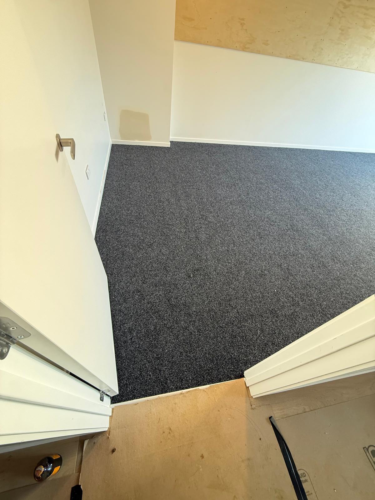 Second storage corner finished with the same charcoal carpet installation