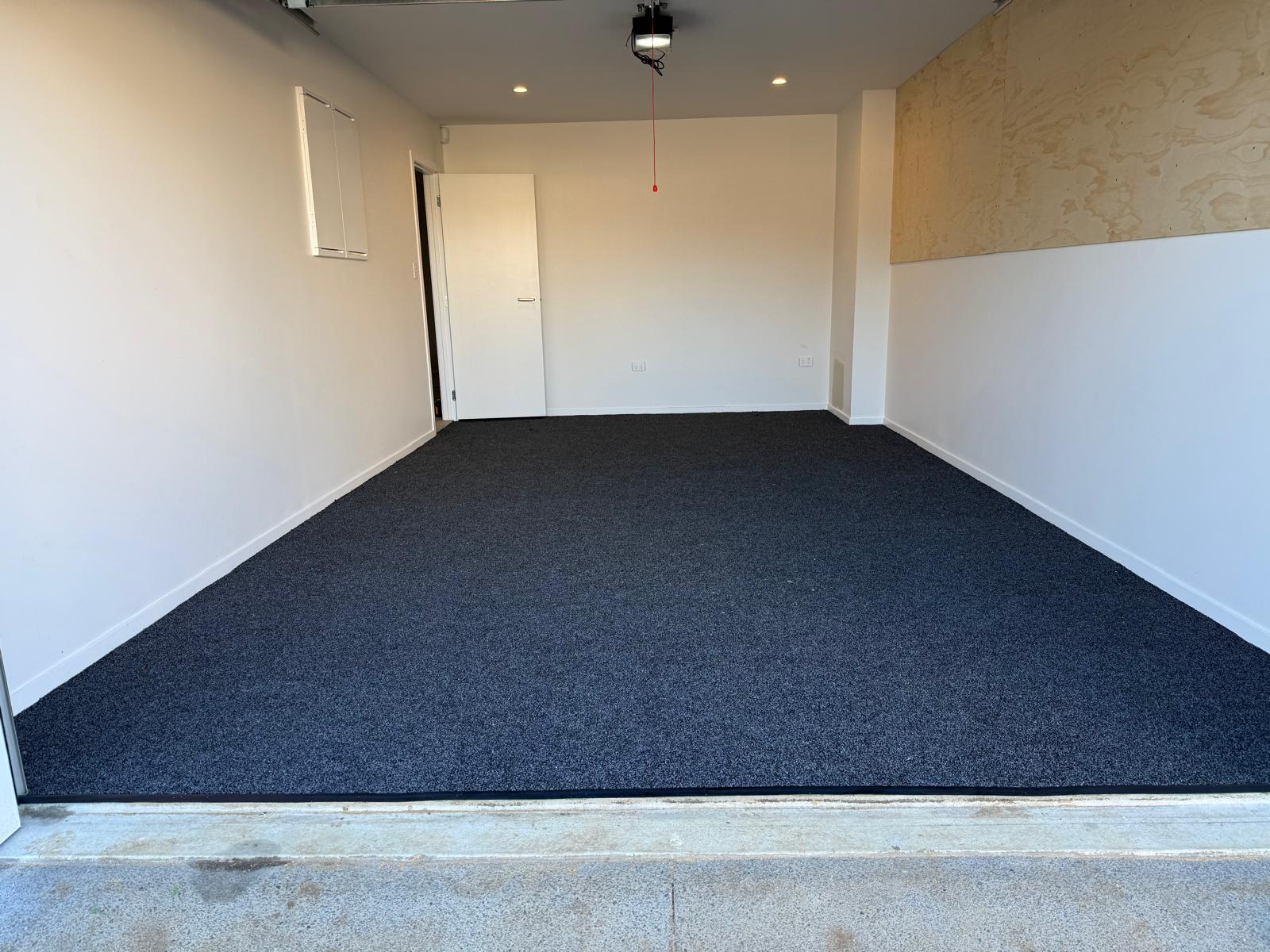 Finished store room with dark brown carpet laid neatly wall to wall